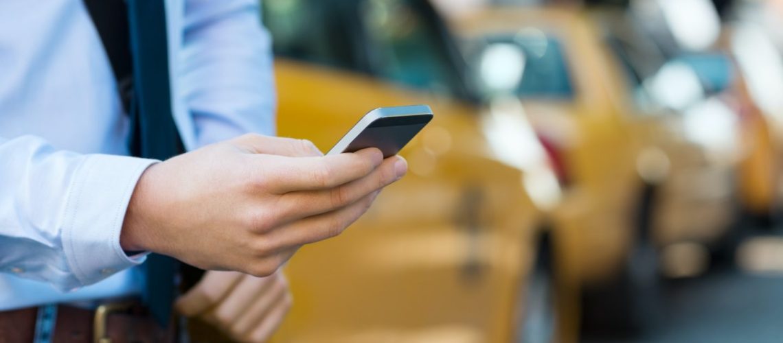 calling-a-taxi-with-phone-e1635074552615